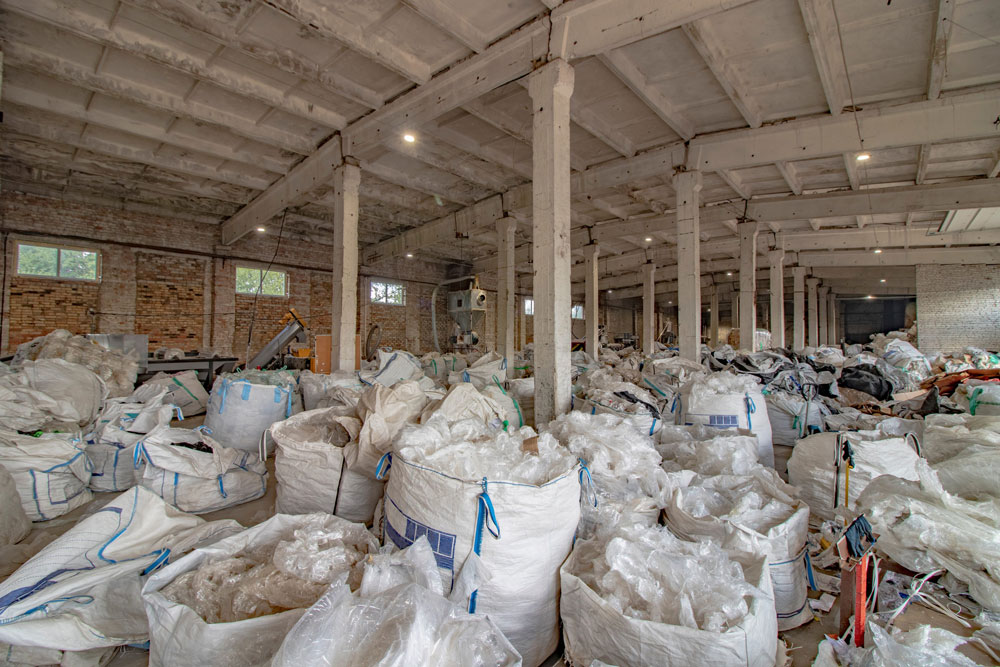 Plastic bag and film recycling plant. Shop for cleaning recyclables from garbage. A lot of stretch film on the production of plastic bags